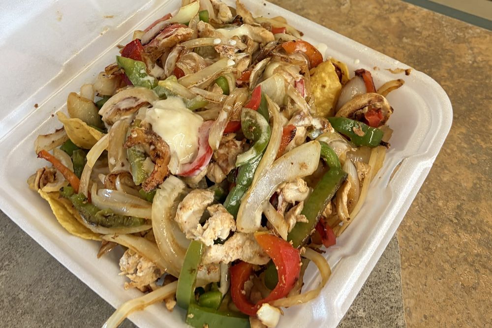 Fajita nachos with grilled chicken, bell peppers, onions and melted cheese