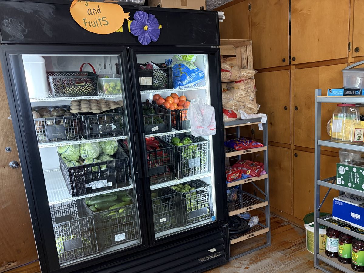 A cooler stocked with fresh vegetables and fruit